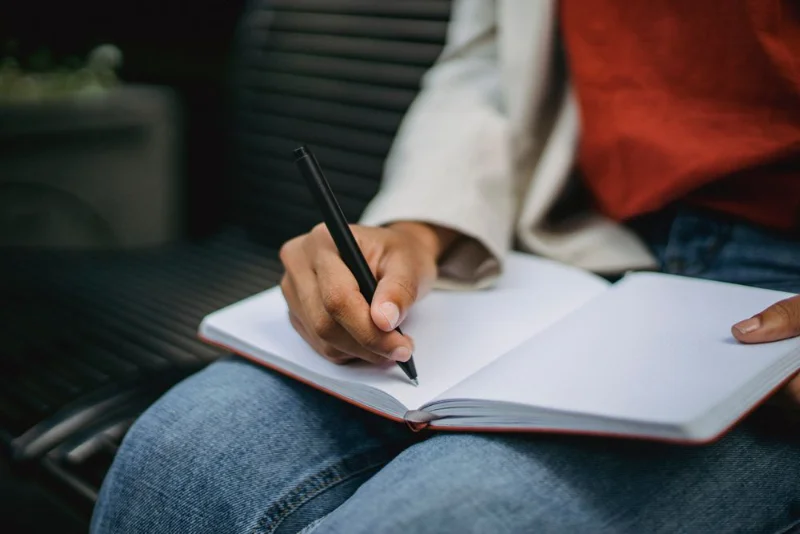 a person journaling in notebook