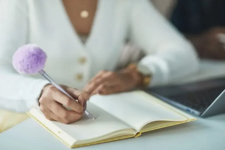 a person writing inside a journal